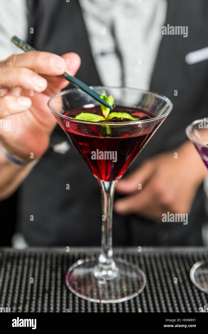 Barman is decorating cocktai Stock Photo
