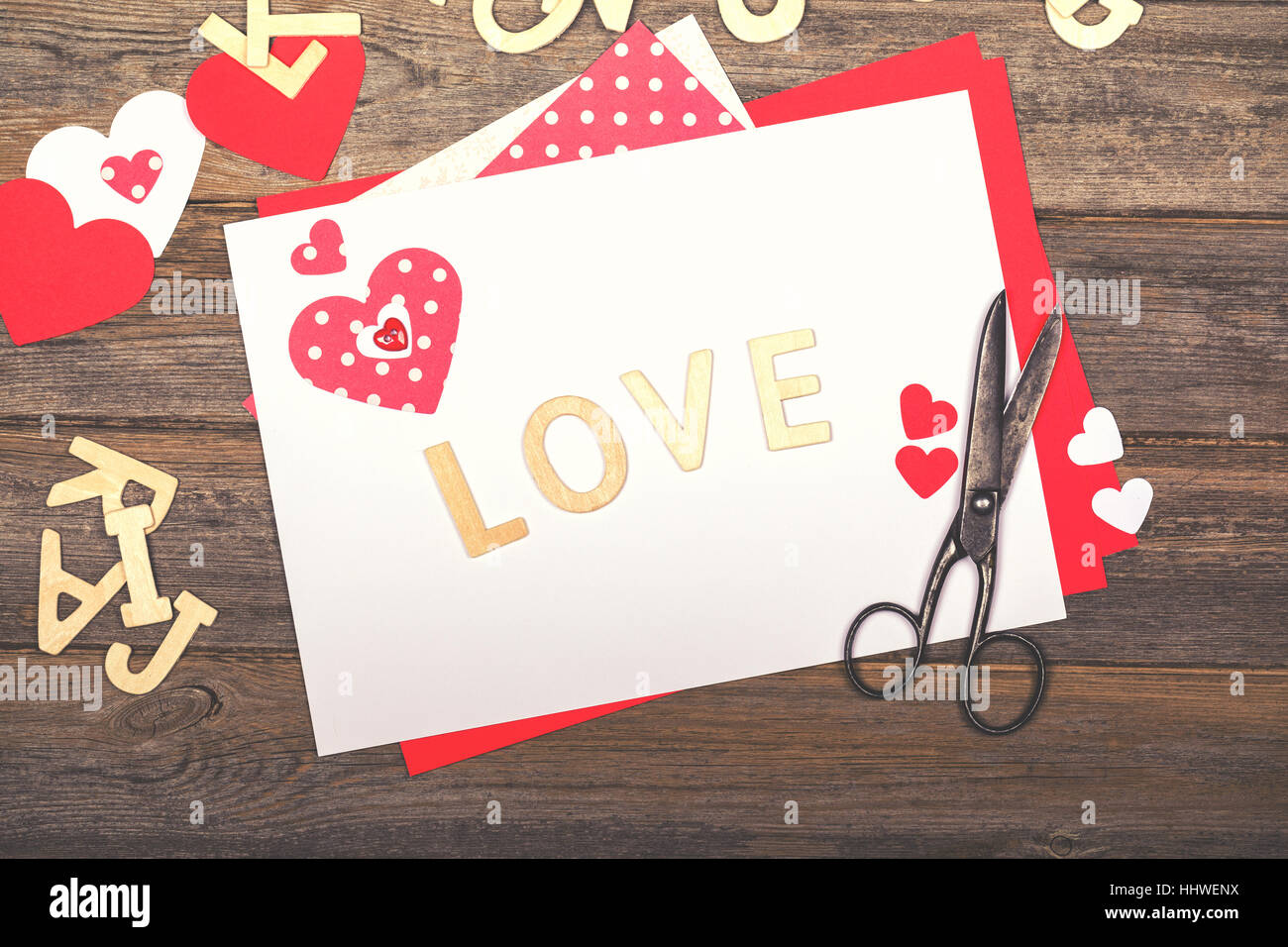 Vintage Valentine and loved themed scrapbooking background, with cutout hearts, wooden letters