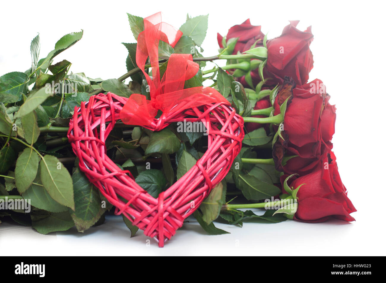 Bouquet of red roses with a heart with ribbon on white isolated ...