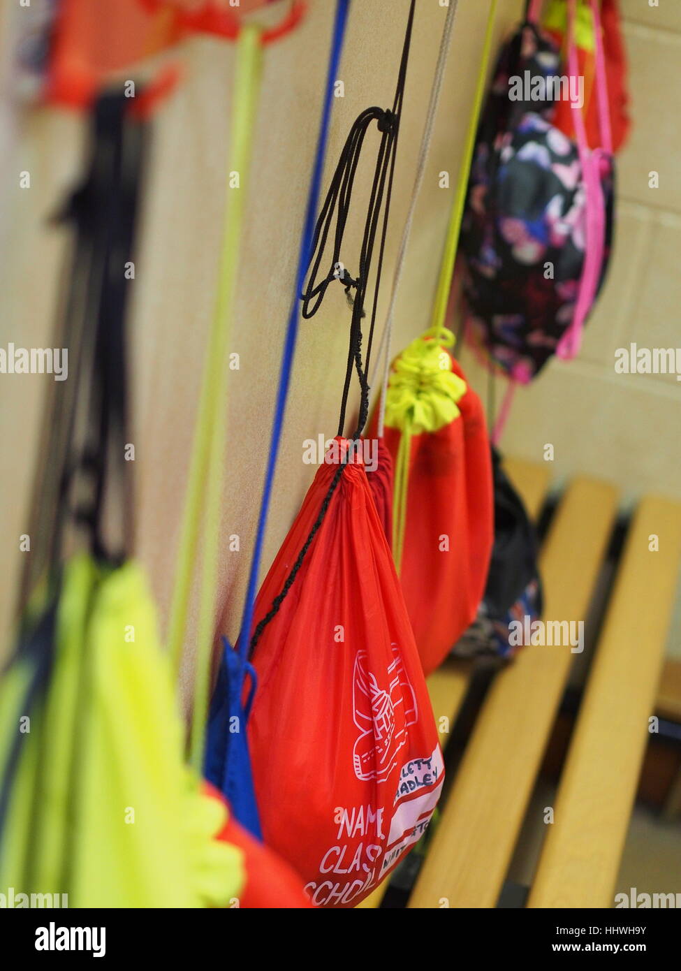 PE bags hanging in primary school cloakroom Stock Photo