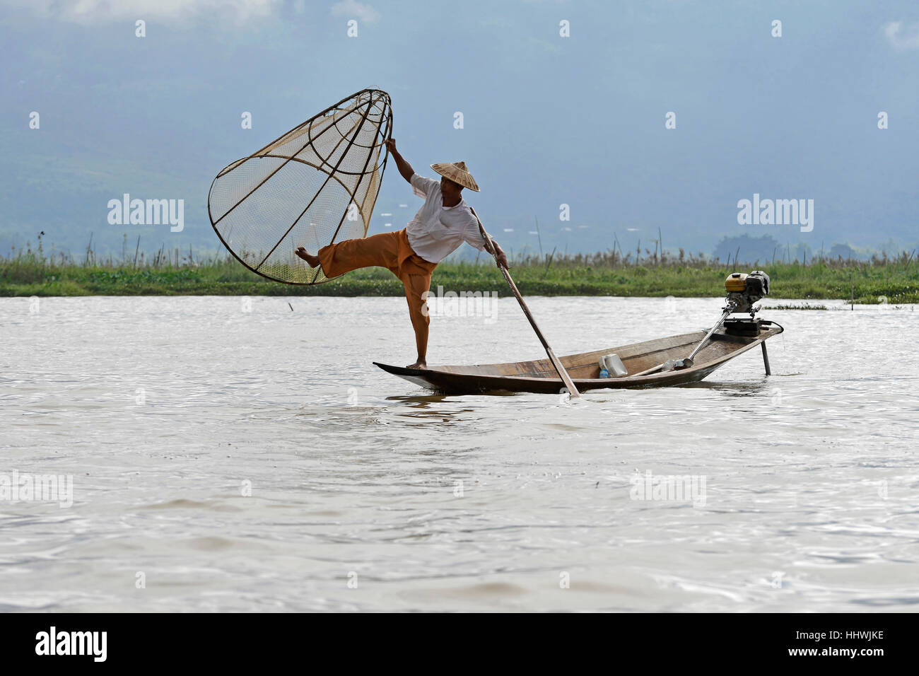 Intha fisherman, local fishing with traditional conical fishing net, Inle Lake, Myanmar Stock Photo
