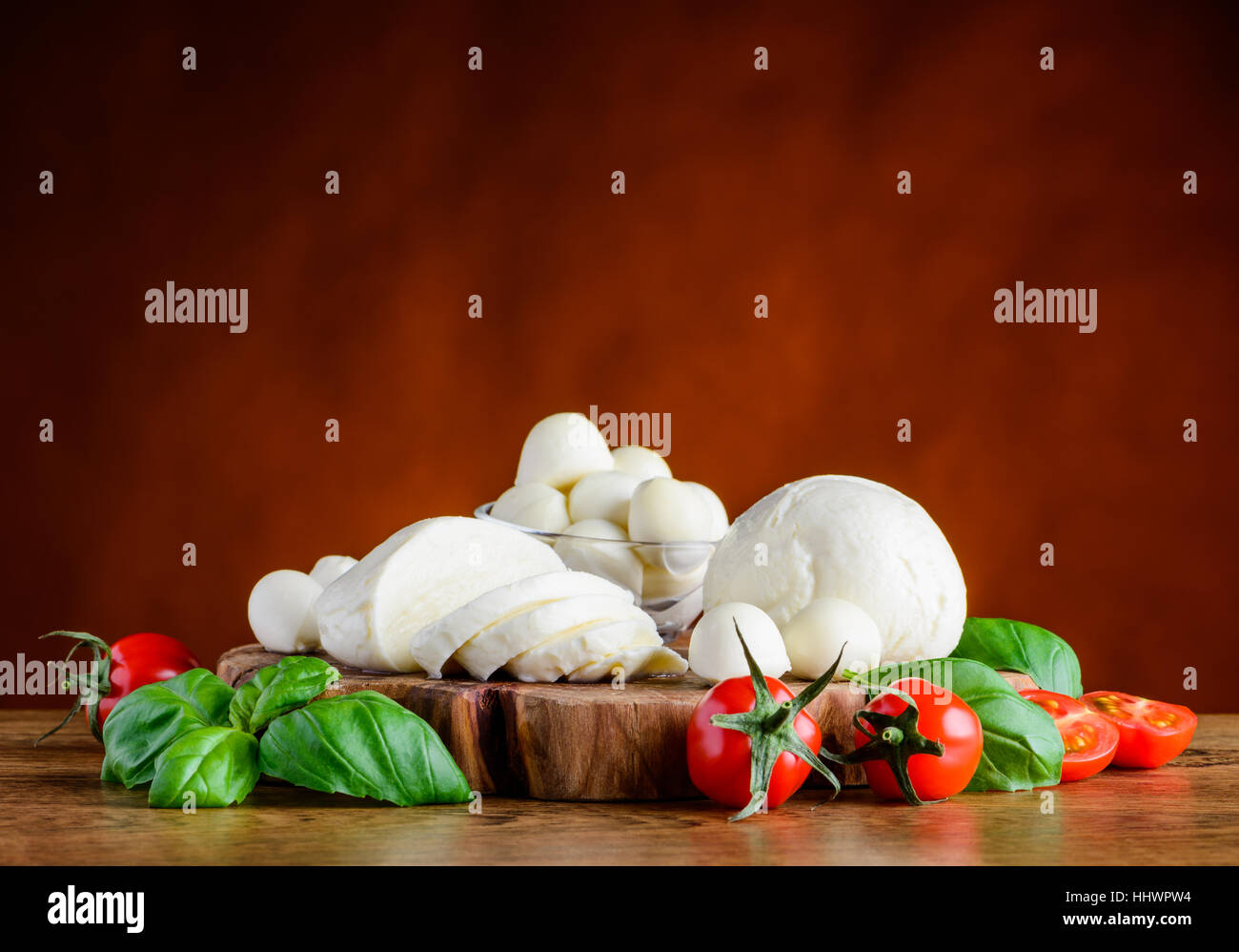 Fresh Italian Mozzarella cheese balls with basil and tomato Stock Photo