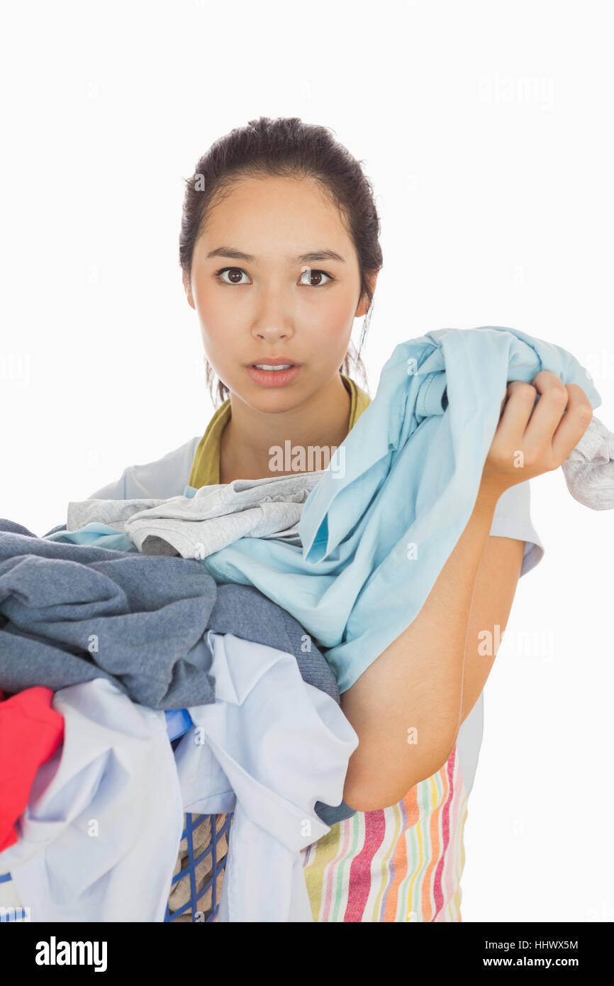 Tired woman holding dirty laundry from the basket Stock Photo Alamy