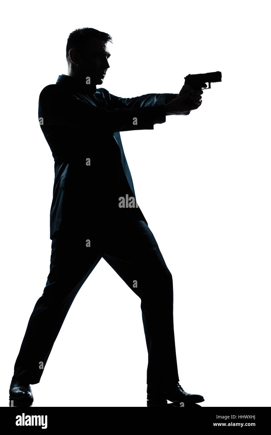 one caucasian  spy criminal policeman detective man aiming shooting gun  full length silhouette in studio isolated white background Stock Photo