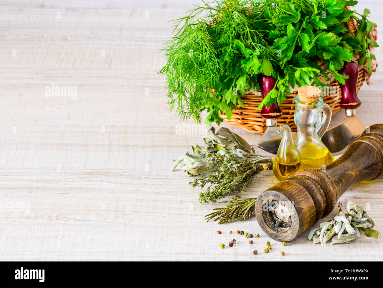 Peppercorn mill Grinder with fresh organic green herbs and copy space