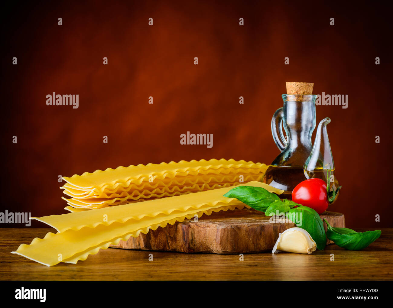 Yellow Reginette Pasta with Olive Oil, Basil and Tomato. Italian Cuisine Lasagna and Seasoning Stock Photo