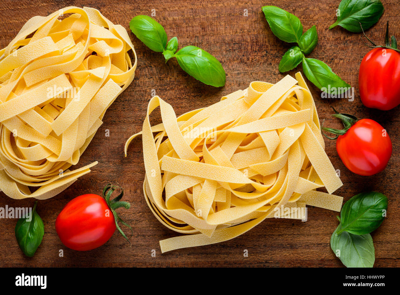 Italian cuisine food, Tagliatelle Tagliolini or Fettucine with tomato and basil Stock Photo