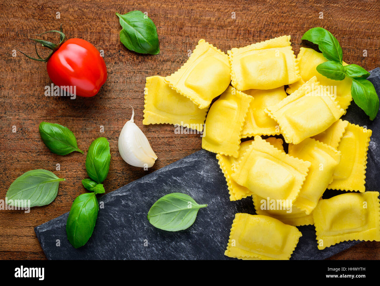 Italian yellow ravioli pasta with tomato, basil and garlic. Italian and mediterranean cuisine food Stock Photo
