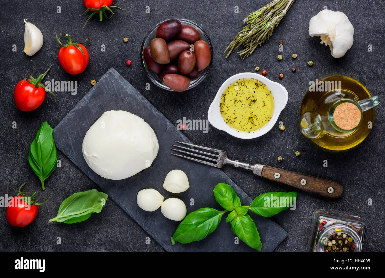 Italian cuisine food with Mozzarella cheese, olives, basil and seasoning Stock Photo