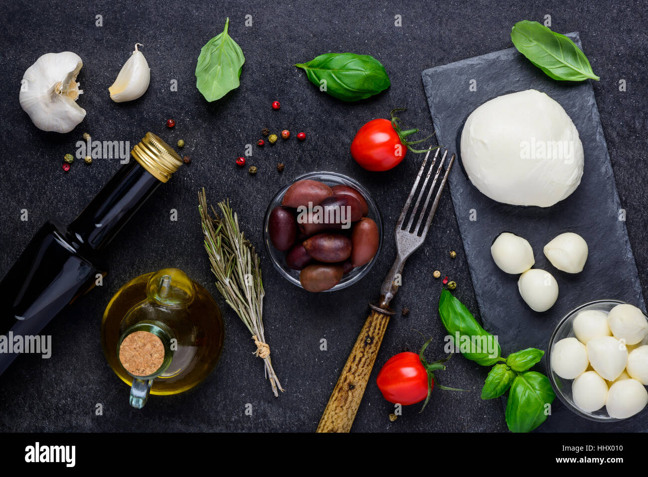 Cooking ingredients and Mozzarella cheese balls with basil tomato and seasoning Stock Photo