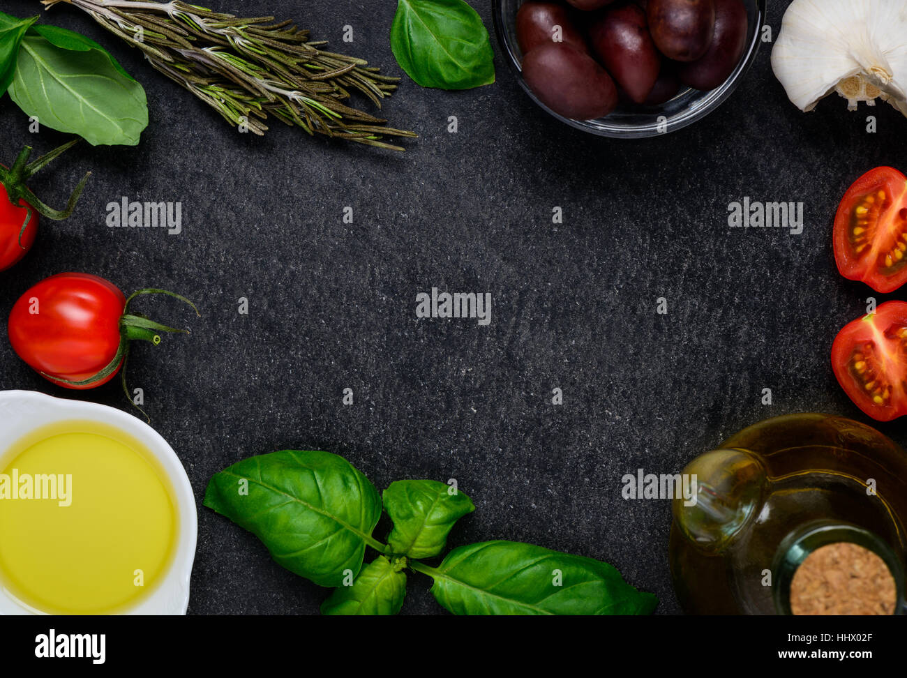 Copy Space Frame made out of cooking ingredients, cheese, olive oil, olives, basil. Stock Photo