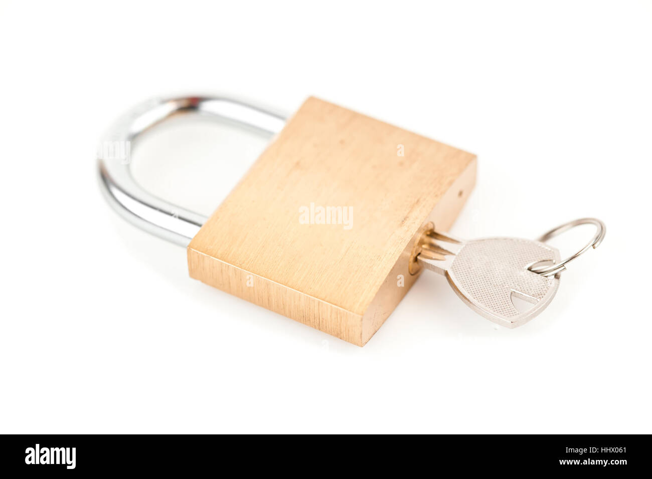 Key in padlock against white background Stock Photo - Alamy