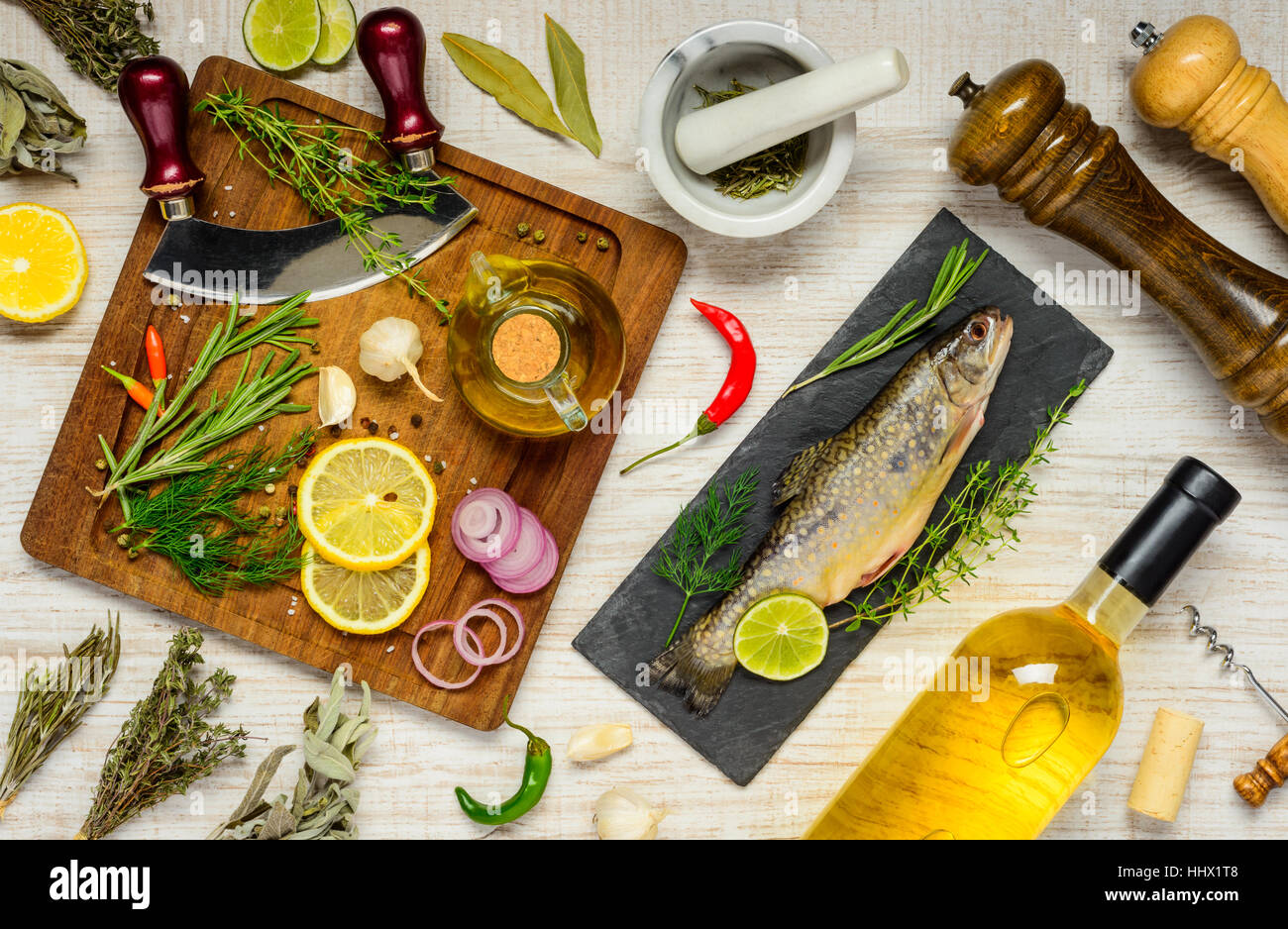 Raw Rainbow Trout Fish with Herbs, spices, seasoning and cooking ingredients. Stock Photo