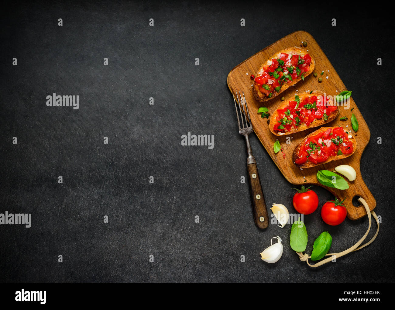 Italian Cuisine Food with Bruschetta Antipasto with Tomato and Basil on Copy Space Text Area Stock Photo