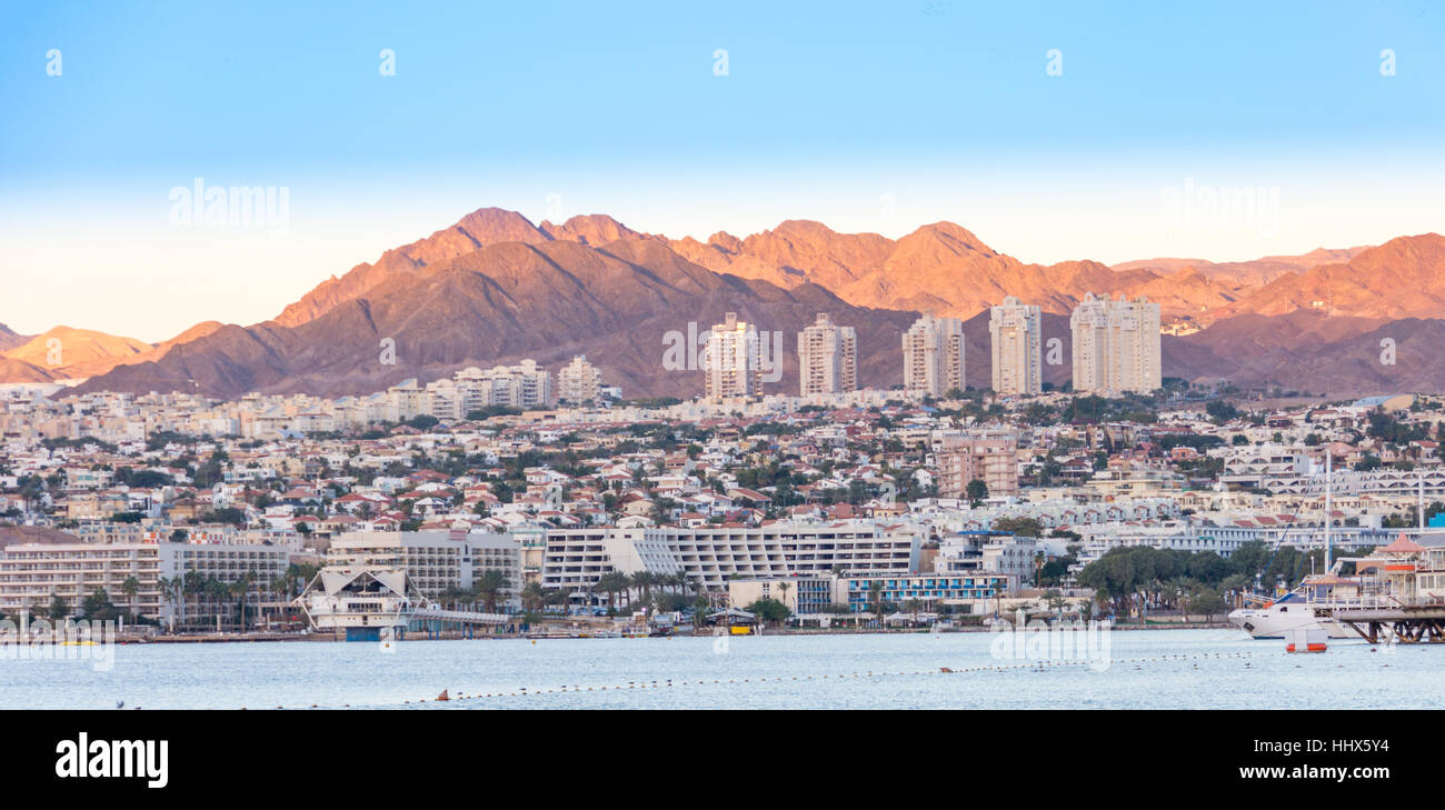 The southern Israel resort city of Eilat, the Red Sea Gulf of Aqaba, and the Negev Desert mountains at sunrise Stock Photo