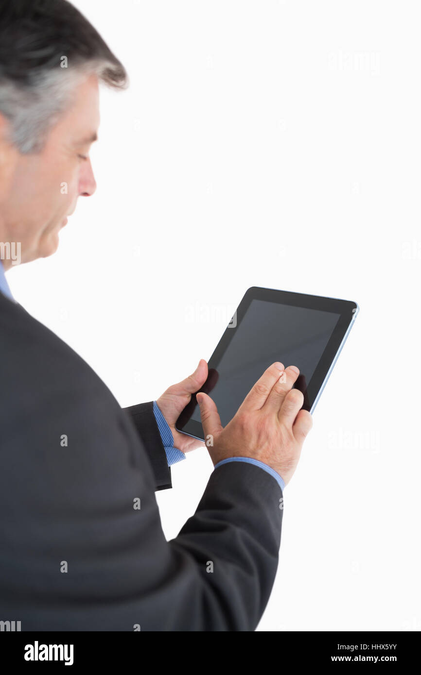 Businessman scrolling through his tablet pc Stock Photo - Alamy