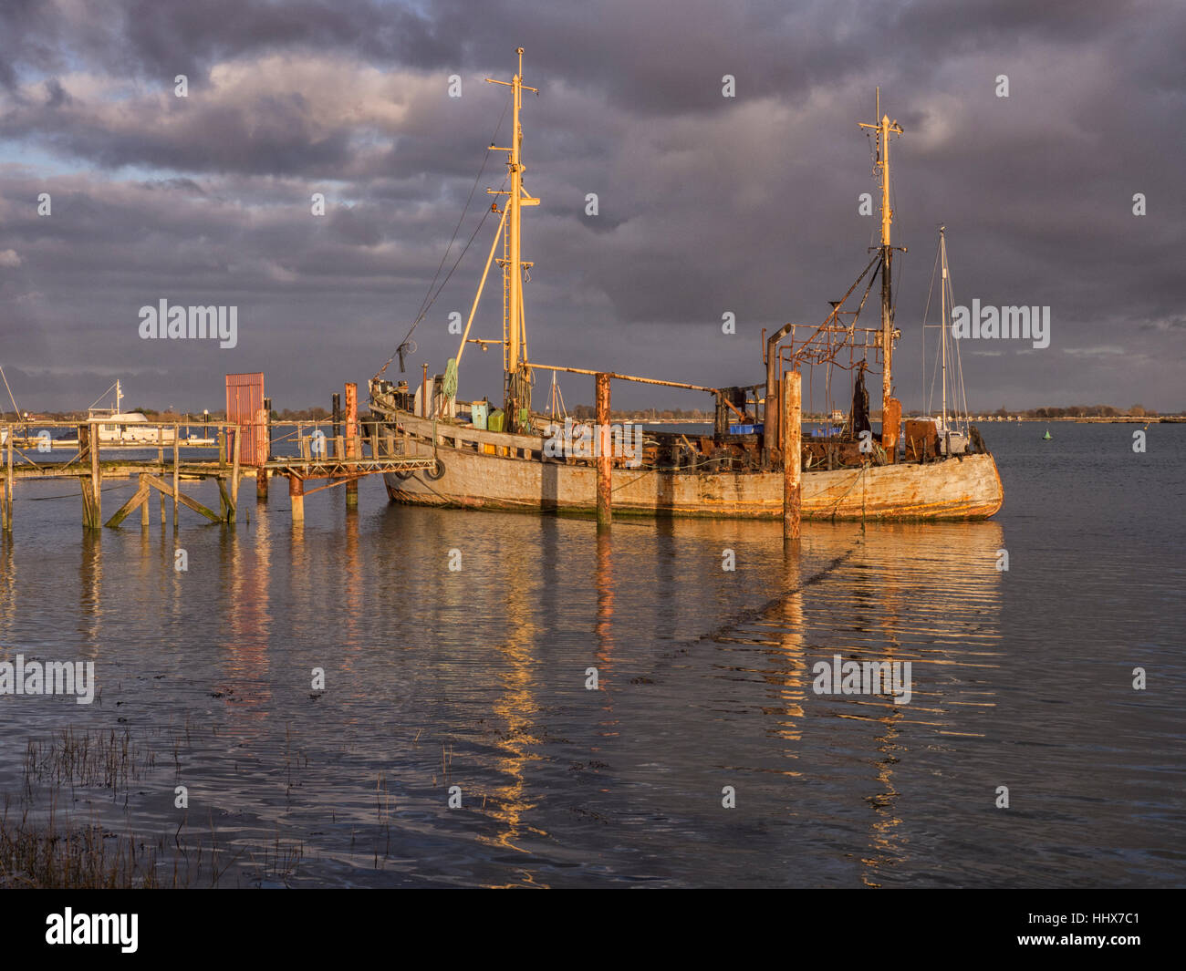 A slowly dilapidated two mast boat moored at the Heybridge Basin in