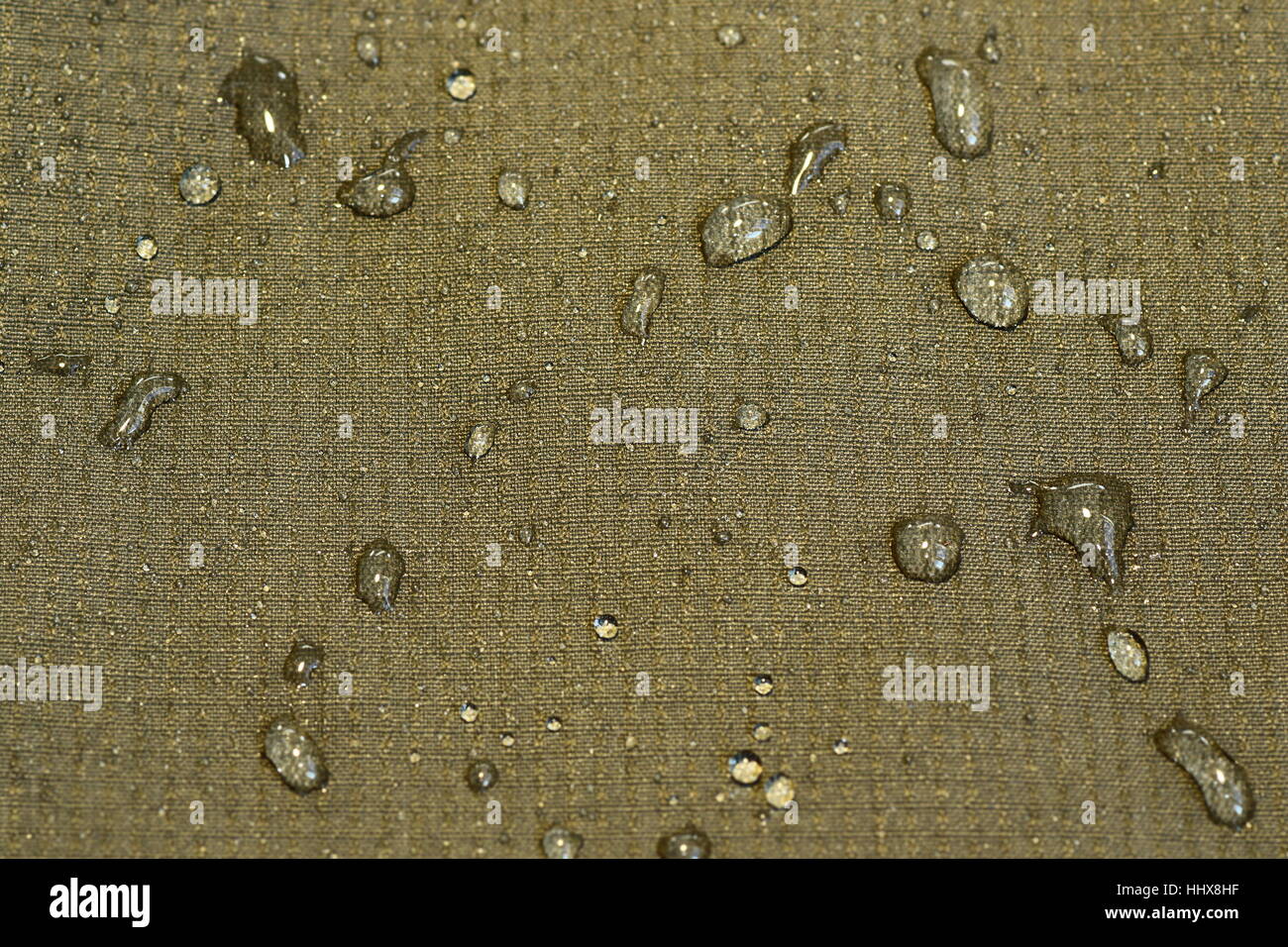 detail of water repellent green material with drops Stock Photo
