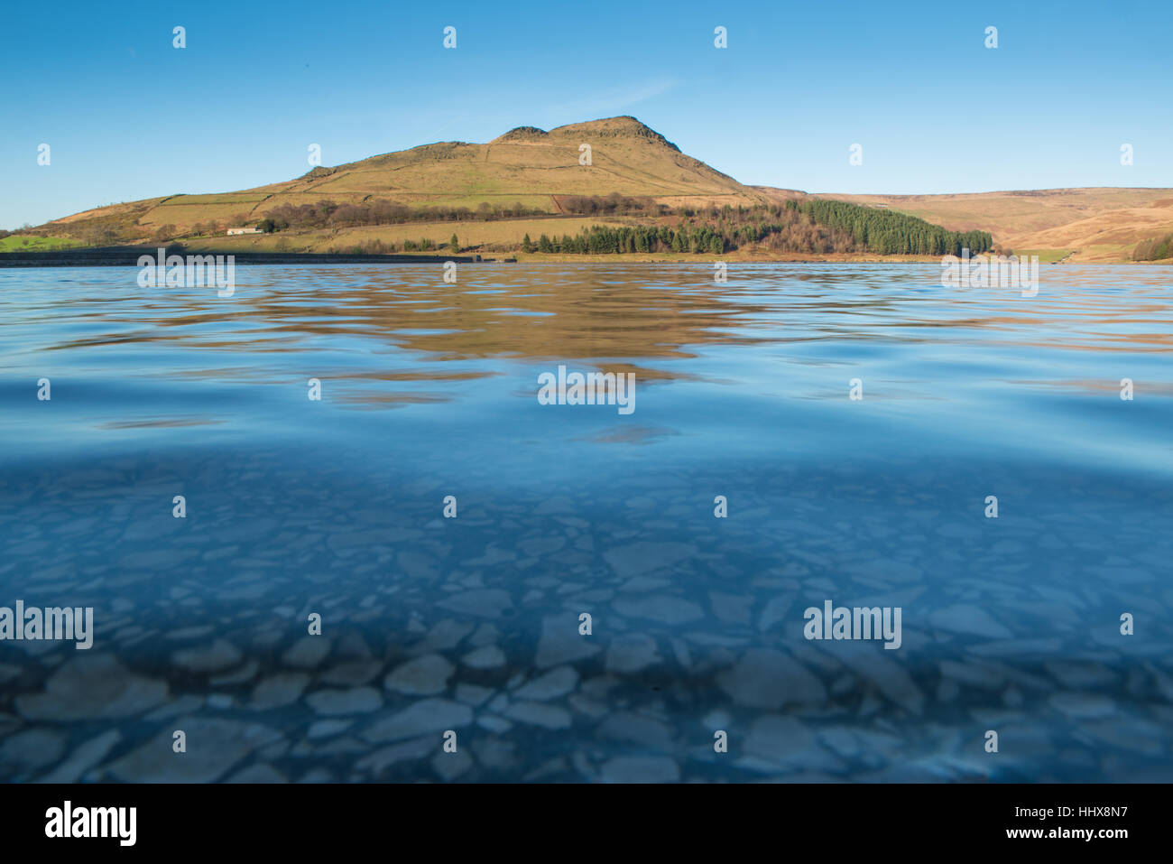 A mid afternoon view of Dovestone Reservoir from a low point of view on a clear winter afternoon. Stock Photo