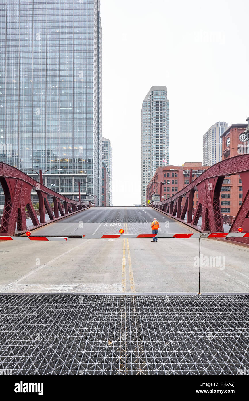 Chicago, USA - October 15, 2016: An unidentified man supervising the opening of movable bridge. Stock Photo