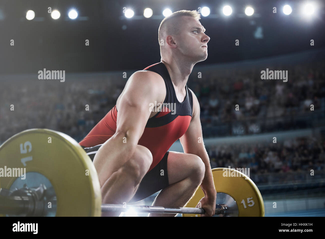 Focused male weightlifter lifting barbell Stock Photo
