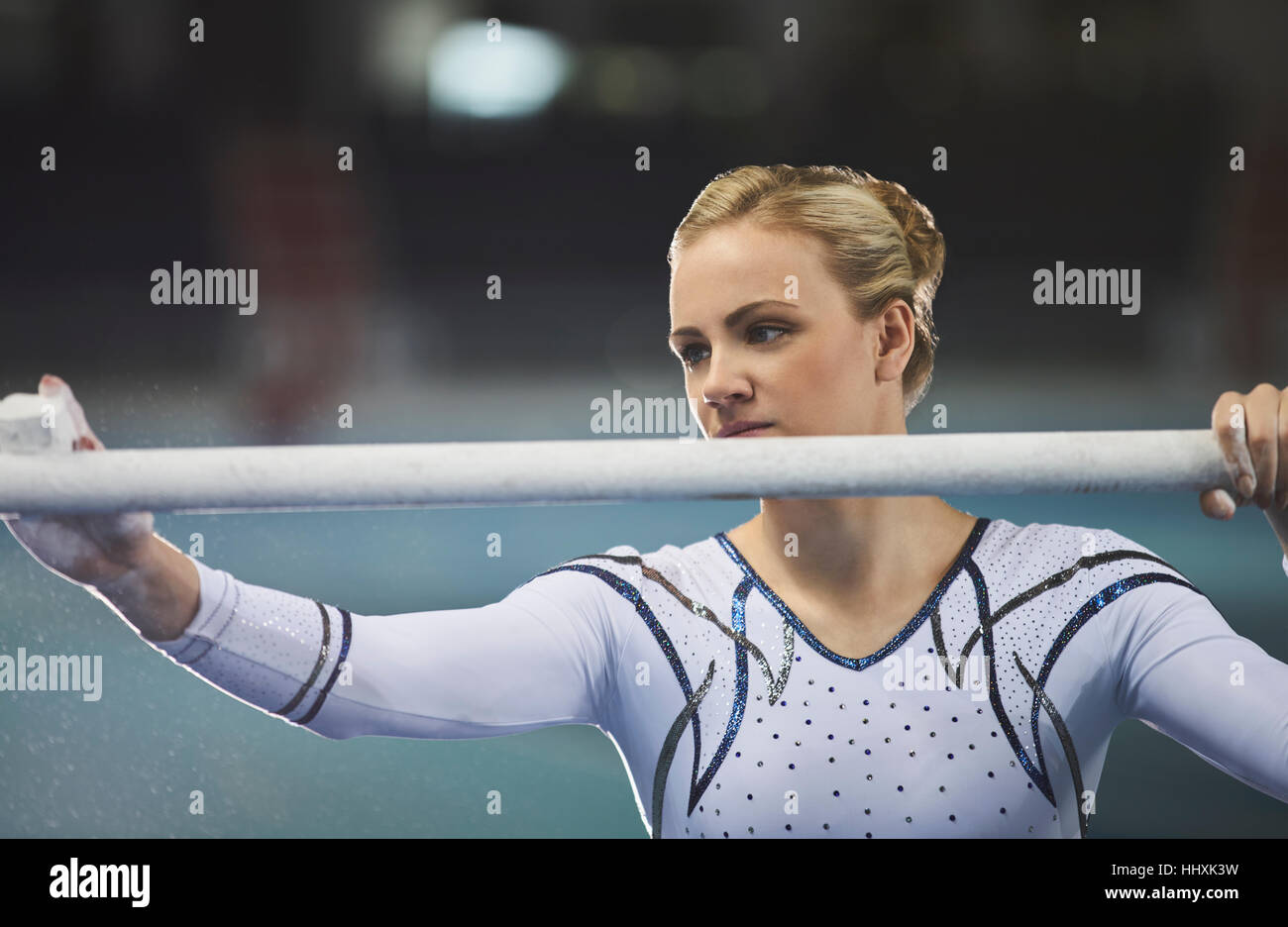 Female gymnast chalking uneven bars Stock Photo Alamy