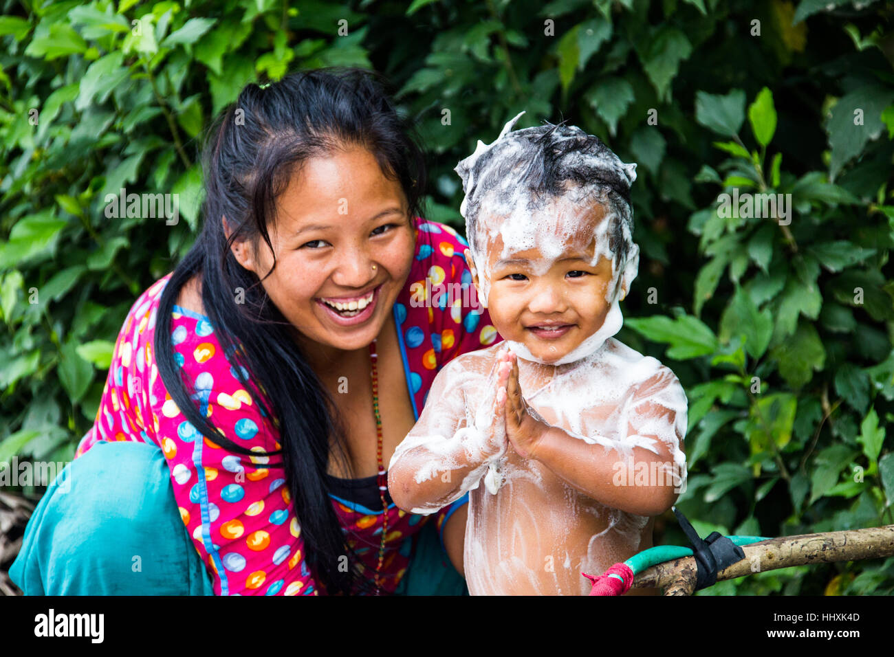 Namaste, baby being given a bath in the hills above Kathmandu, Nepal