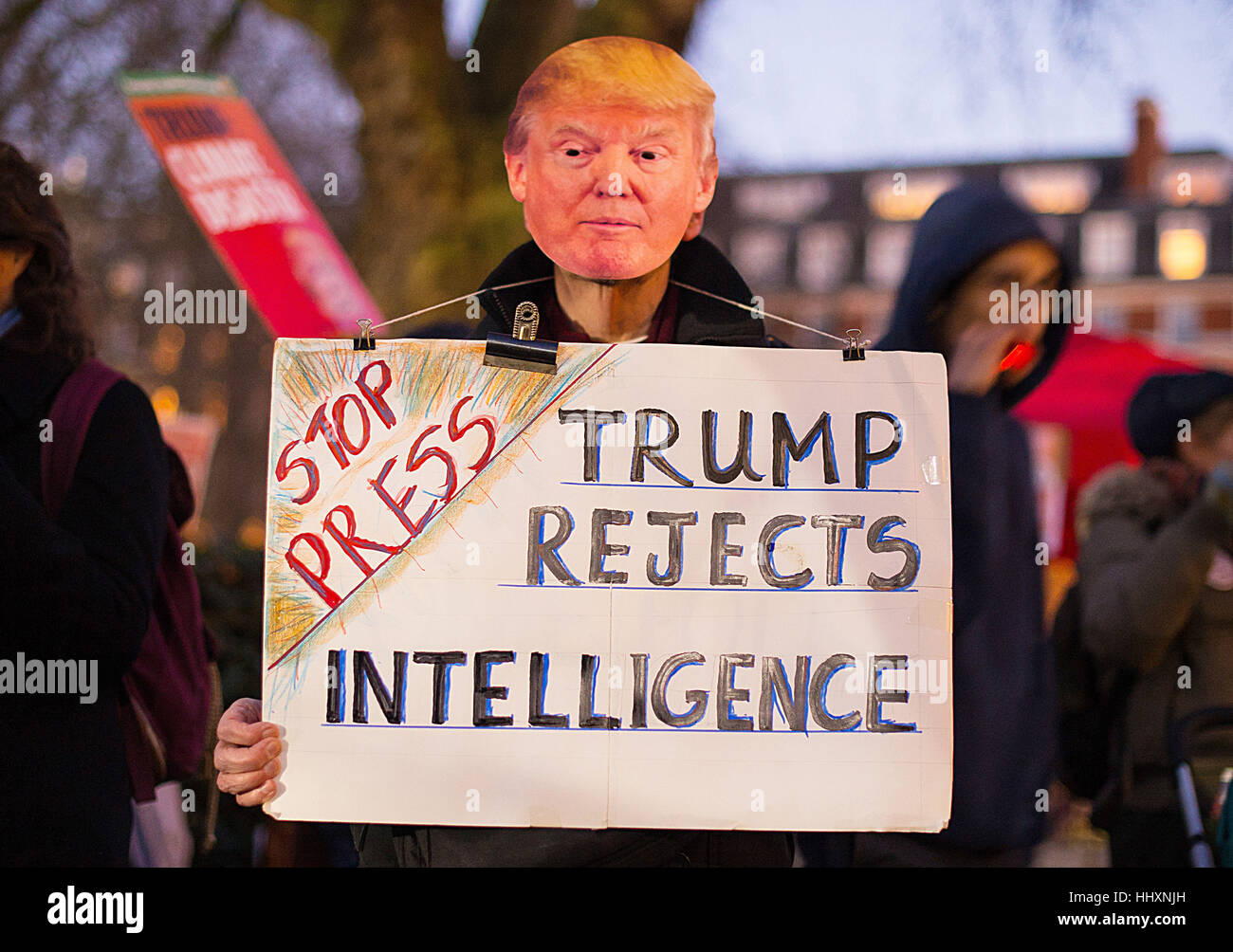 A protestor wearing a Donald Trump mask takes part in a demonstration outside the US Embassy, in Grosvenor Square, London, following the inauguration of US President Donald Trump. Stock Photo