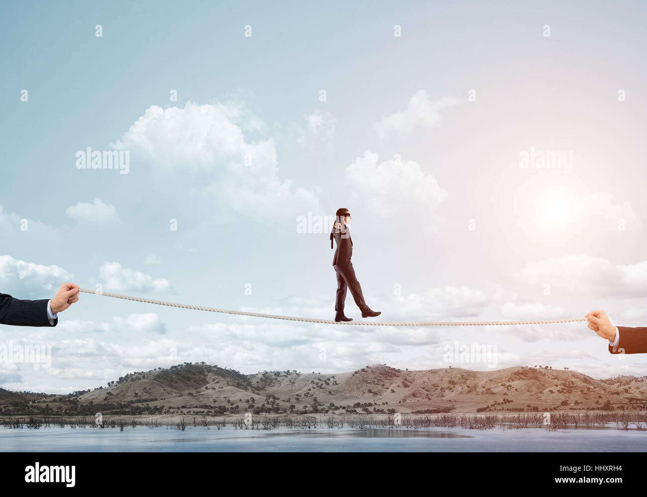 Business concept of risk support and assistance with man balancing on ...