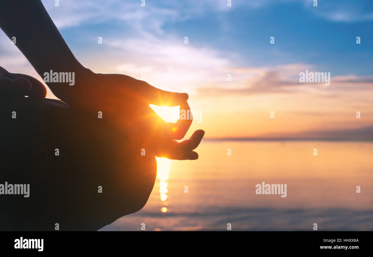 serenity and yoga practicing at sunset meditation Stock Photo