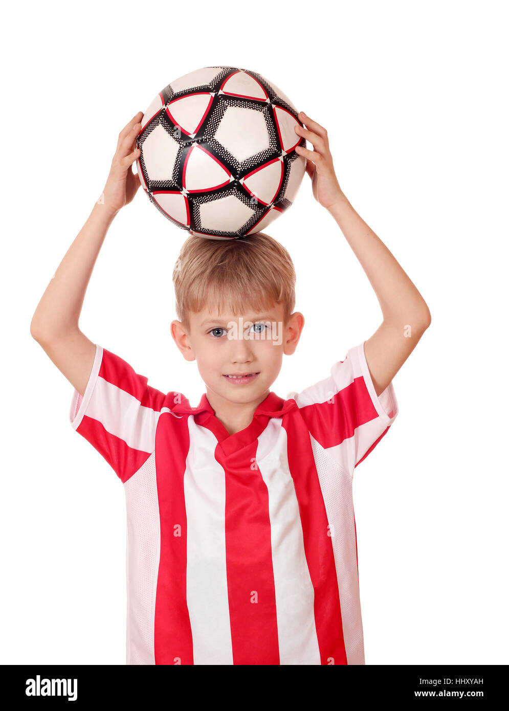 boy holding a soccer ball above his head Stock Photo Alamy
