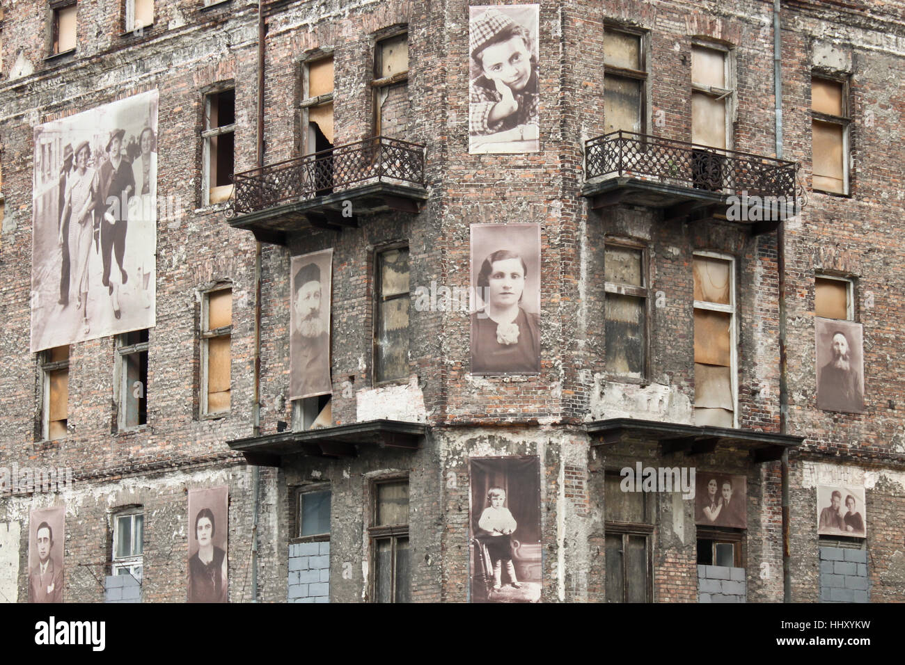 WARSAW, POLAND - SEPTEMBER 1, 2012: Holocaust memorial - a building from Warsaw ghetto with pictures of jews on the facade. Stock Photo