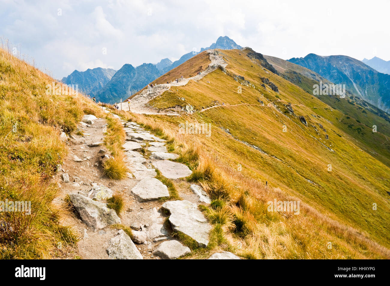 Path on the steep side of Kasprowy Wierch in Tatra mountains and a view of the border between Poland and Slovakia. Stock Photo