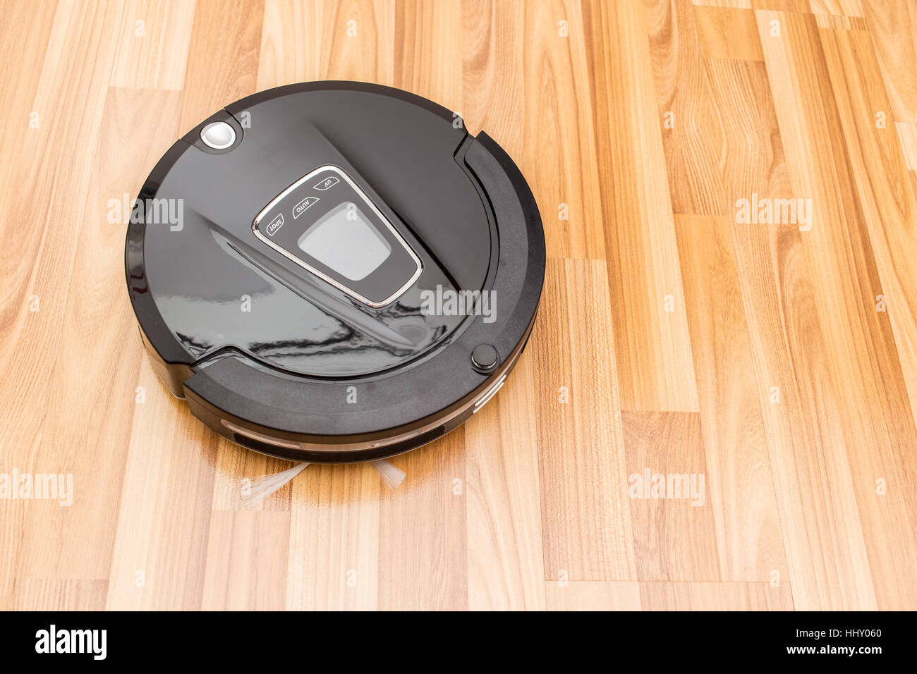 Robotic vacuum cleaner on wood parquet floor, Smart vacuum, new automate technology housework. Stock Photo