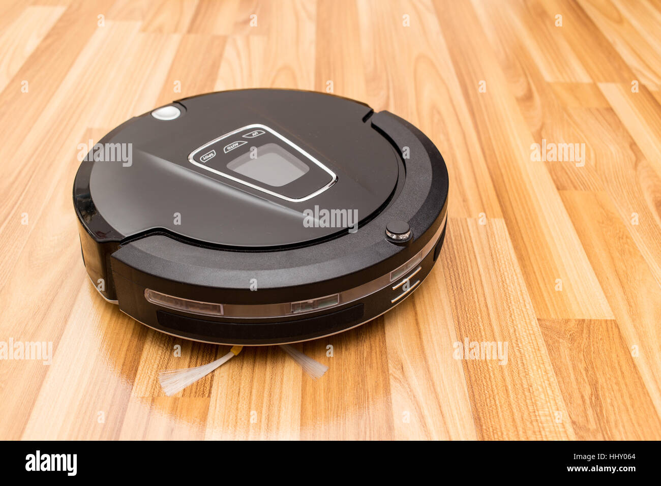 Robotic vacuum cleaner on wood parquet floor, Smart vacuum, new automate technology housework. Stock Photo