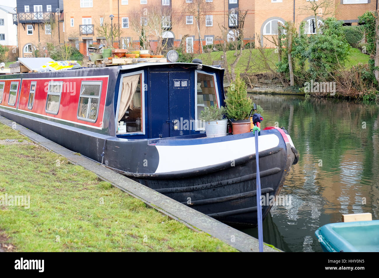 A blue and red barge moored on a canal in Hertford, England Stock Photo