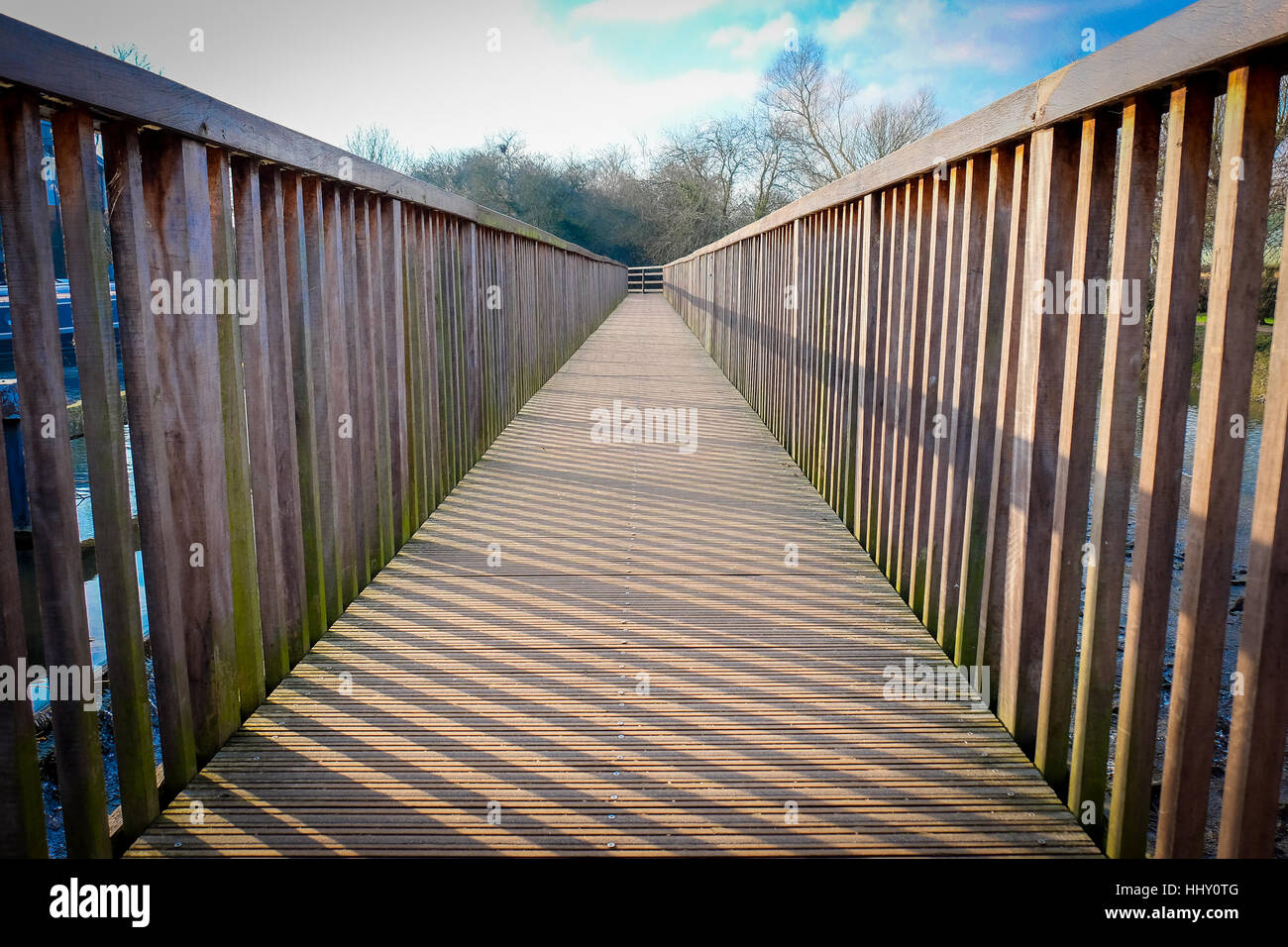 A wooden walkway extends into the distance Stock Photo