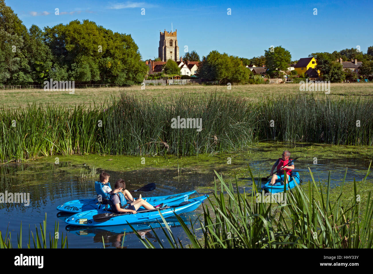 Kayaks on the river Stour as it flows through Sudbury Meadows, Suffolk,   with the tower of All Saints church in the background Stock Photo