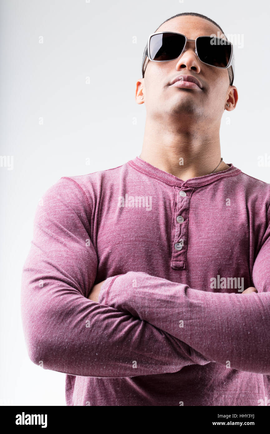 proud and self confident handsome black man with sunglasses and arms folded Stock Photo