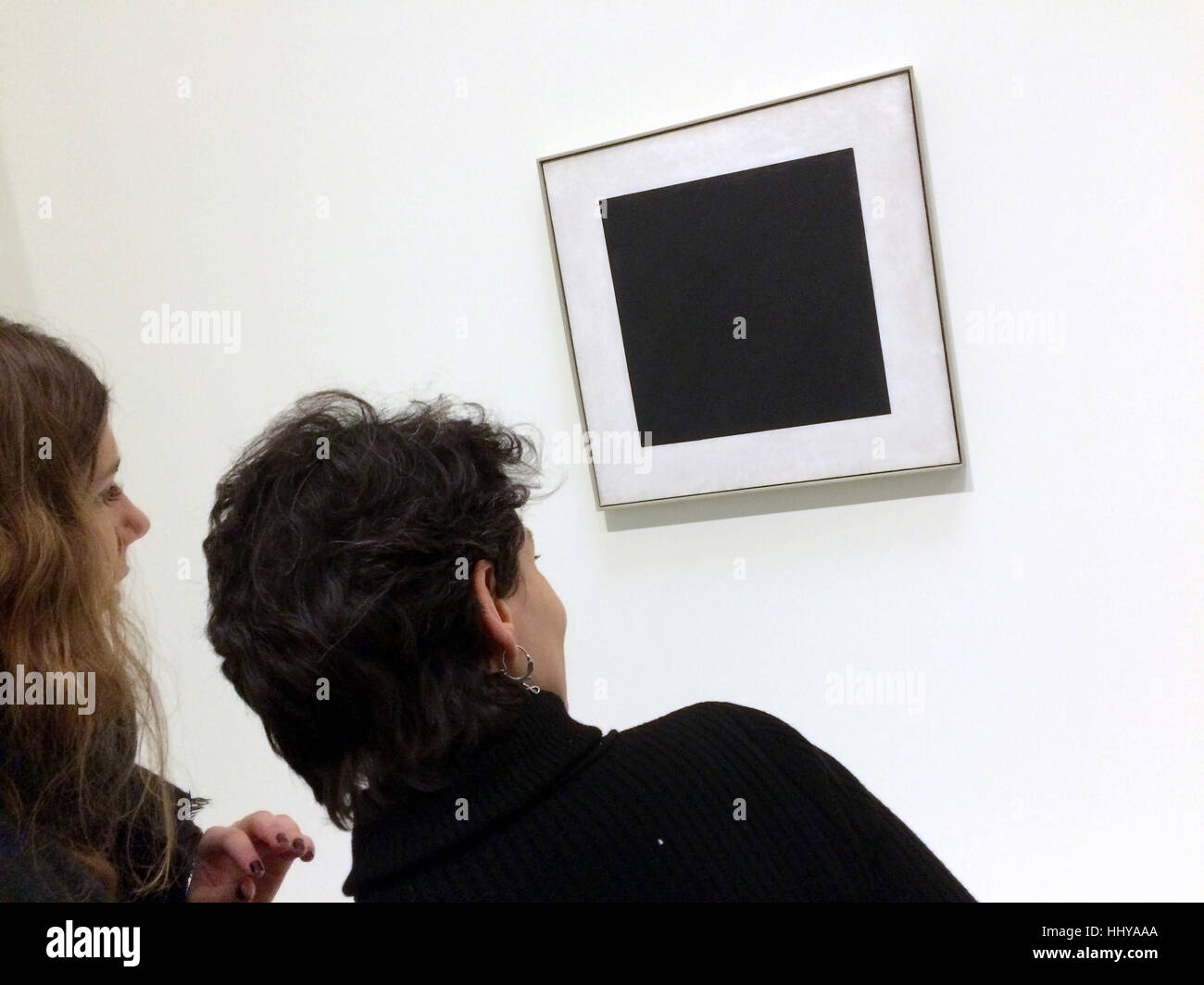 Visitors in front of the painting Black Square (1929) by Russian avant-garde painter Kazimir Malevich displayed at the exhibition Icons of Modern Art from the Shchukin Collection in the Fondation Louis Vuitton in Paris, France. The exhibition runs till 5 March 2017. Stock Photo