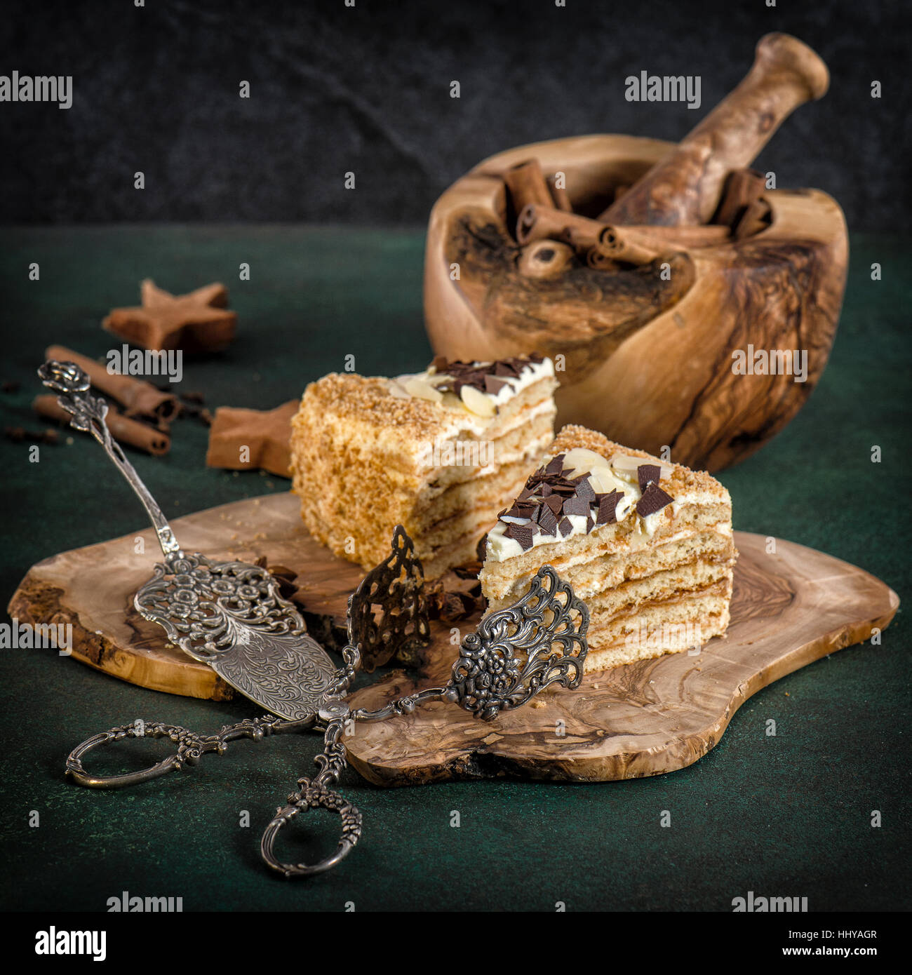 Honey cake with vintage tools on dark background. Sweet food. Retro style toned picture Stock Photo