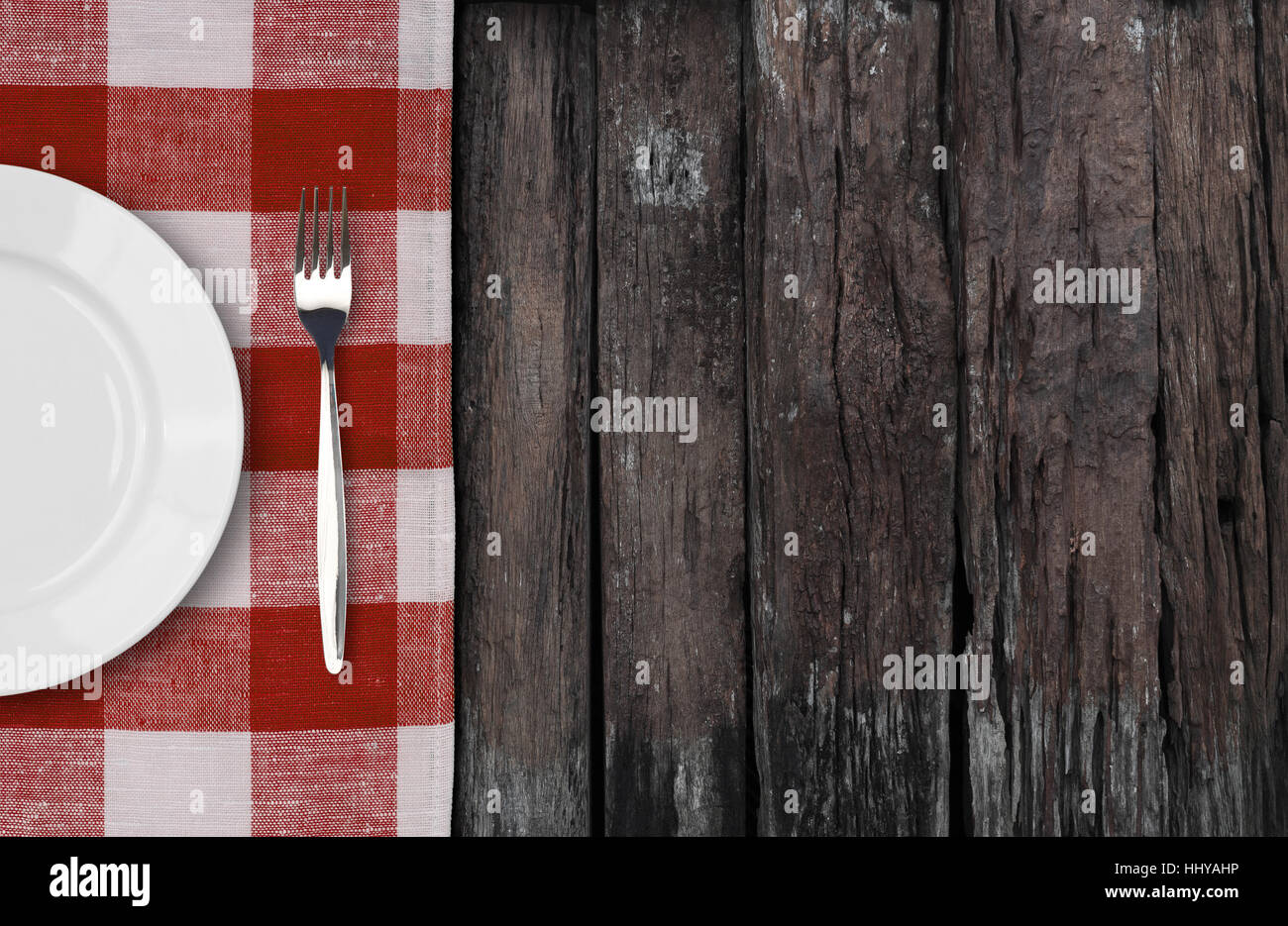 old table with dinner plate setting top view Stock Photo