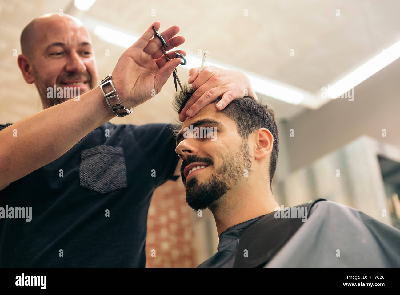 Hairstylist Making Men S Haircut To An Attractive Man In The