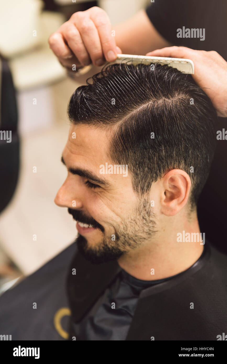 Hairstylist Making Men S Haircut To An Attractive Man In The