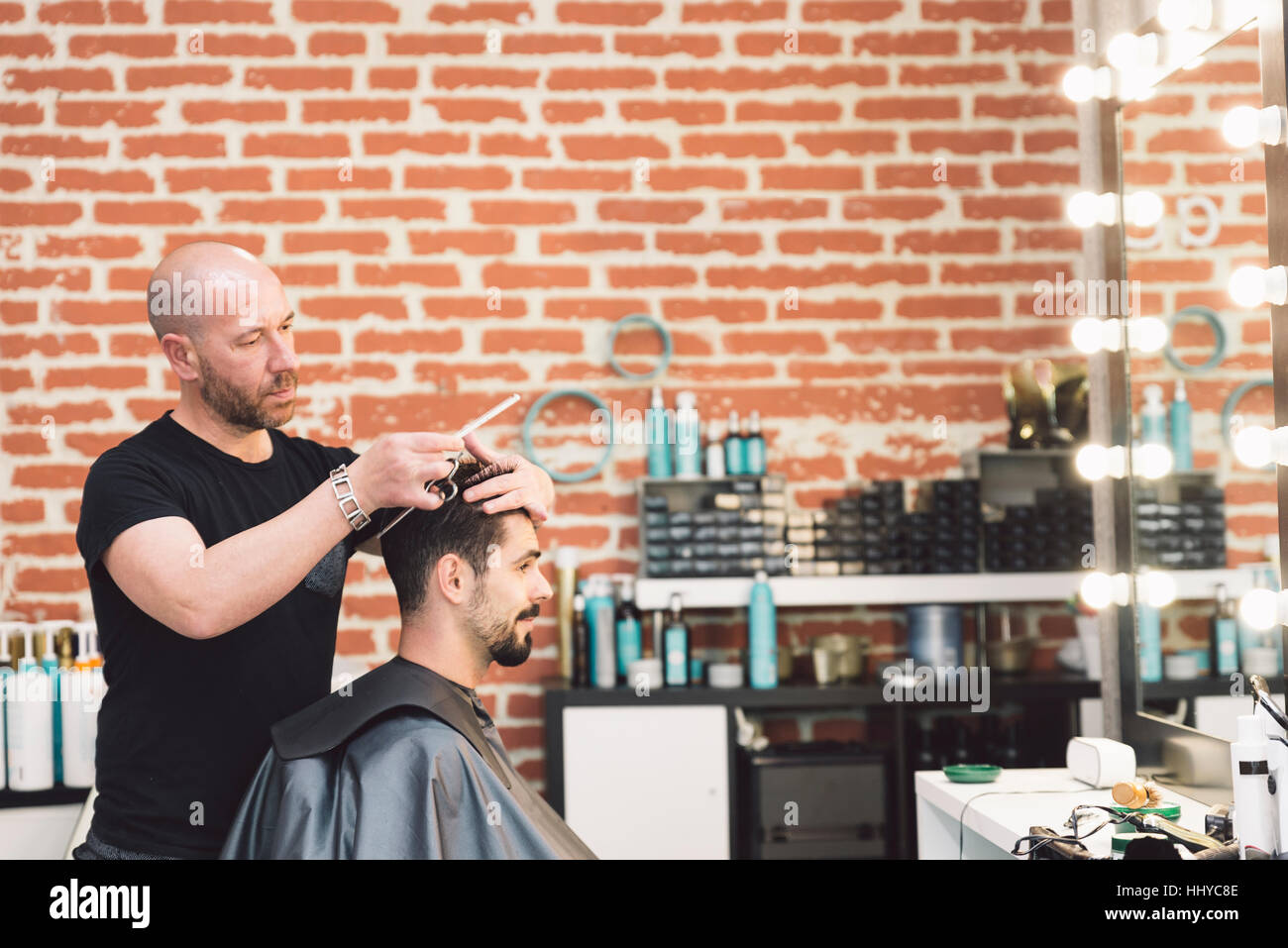 Hairstylist Making Men S Haircut To An Attractive Man In The