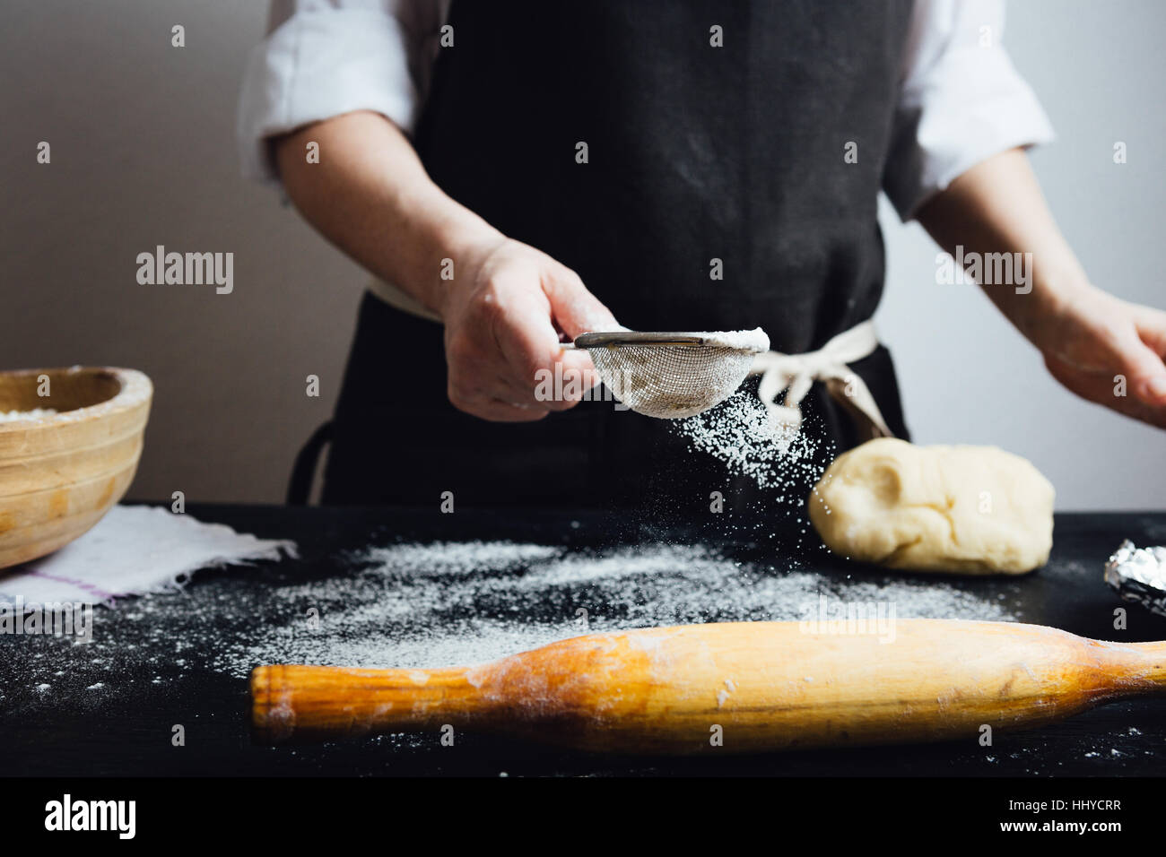 Cook covering table with flour Stock Photo Alamy