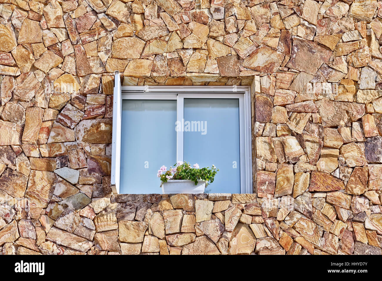 Modern window on old wall with traditional Spanish stonework Stock Photo