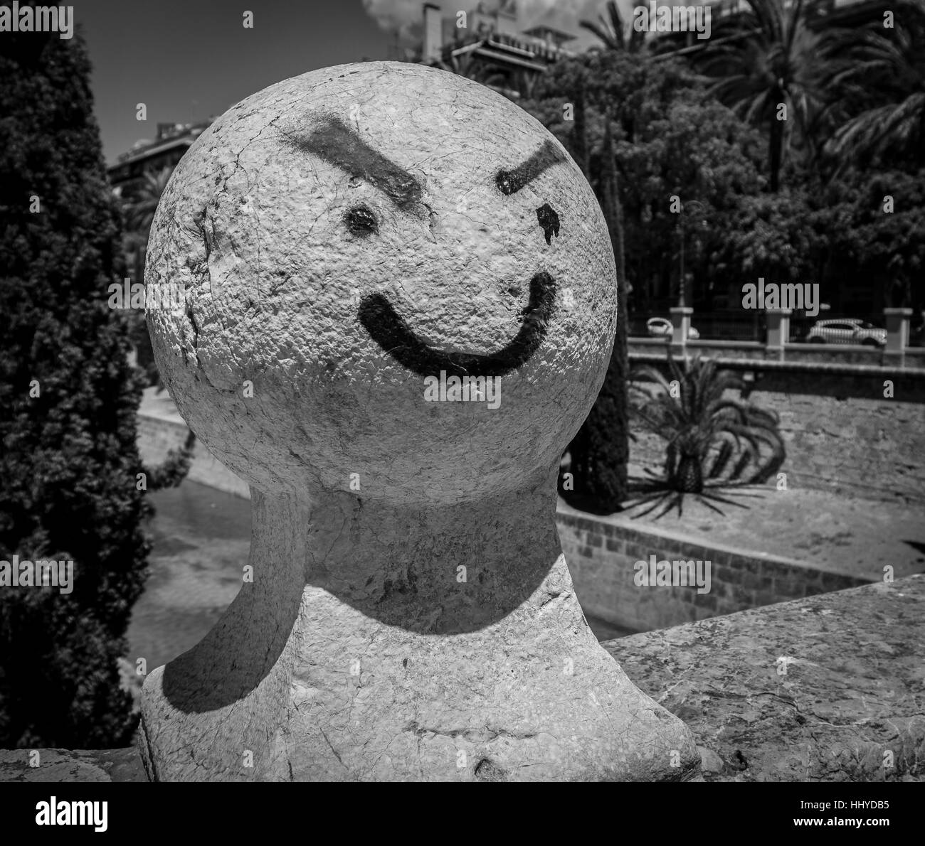 graffiti of face on bridge bollard Stock Photo