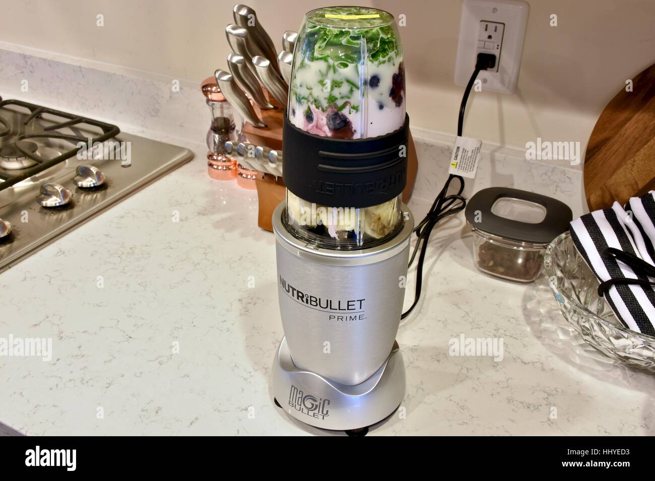 Making a smoothie with the NutriBullet blender in a modern kitchen