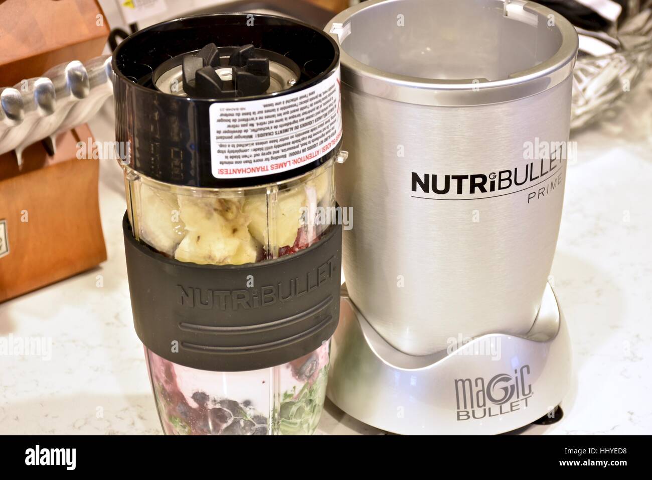 Making a smoothie with the NutriBullet blender in a modern kitchen